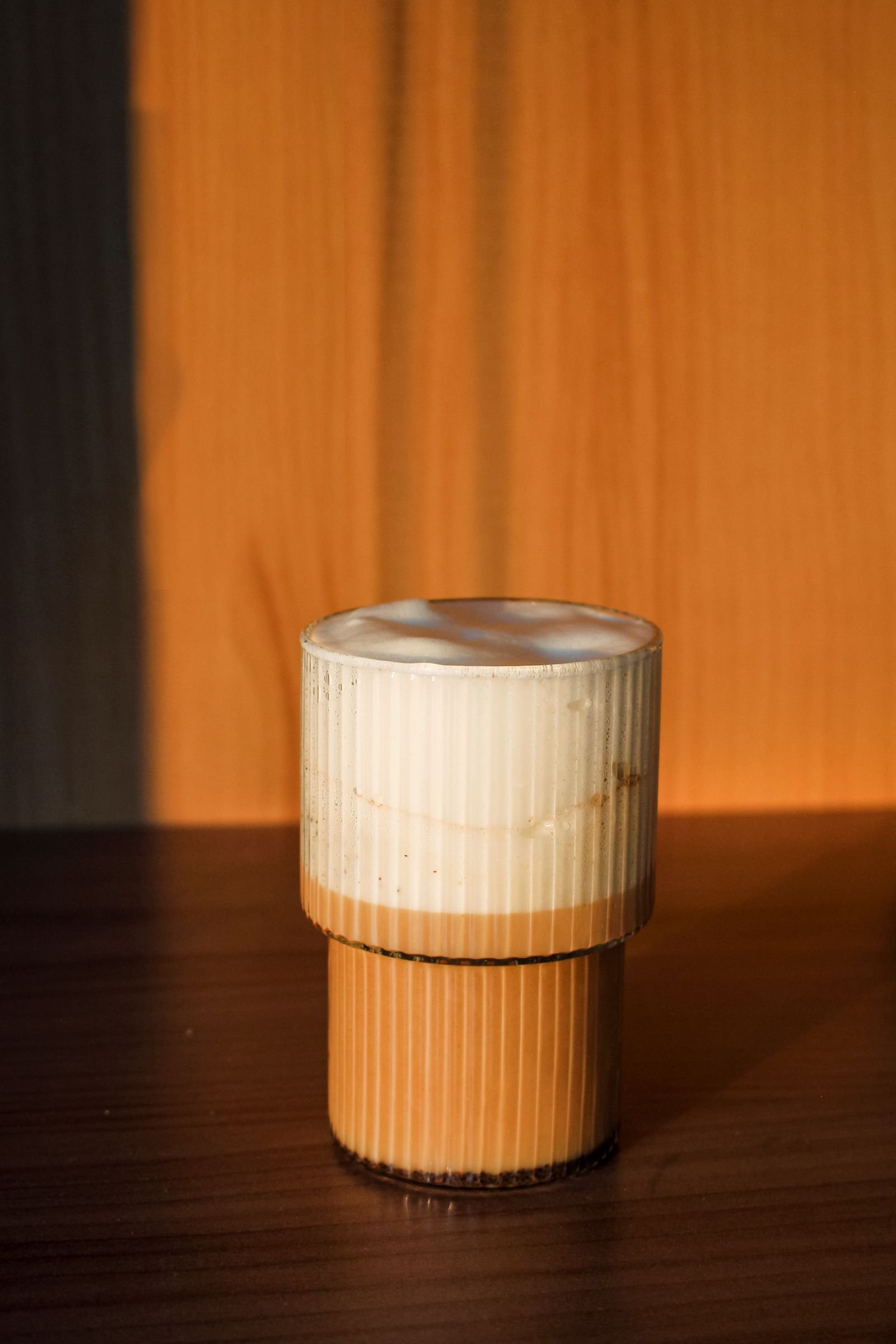Layered iced coffee in warm sunlight